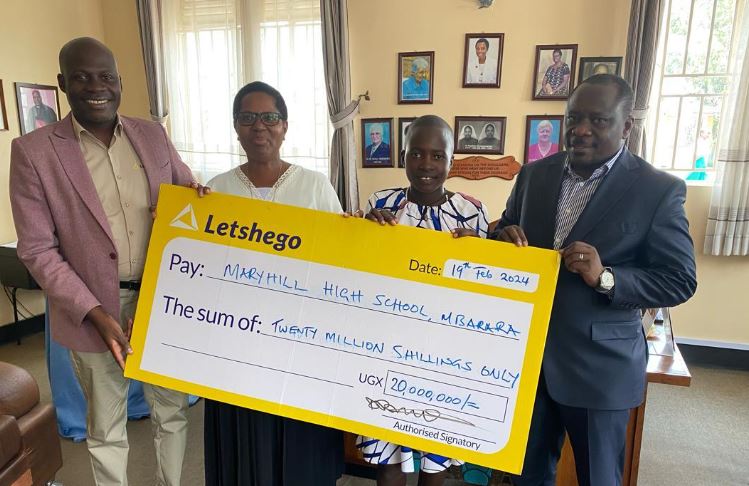 L-R: Dennis Mbiika (Head of Sales Letshego), Sister Sarah Kasya Tumuhimbise (Deputy HM MaryHill), Fortunate Atuhaire (Letshego bursary recipient 2024) & Hon Francis Mwijukye (MP Buhweju) unveil and display UGX20m education bursary from Letshego for 4years at MaryHill High School Mbarara.